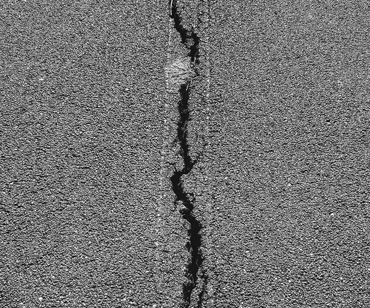 A crack in the pavement.