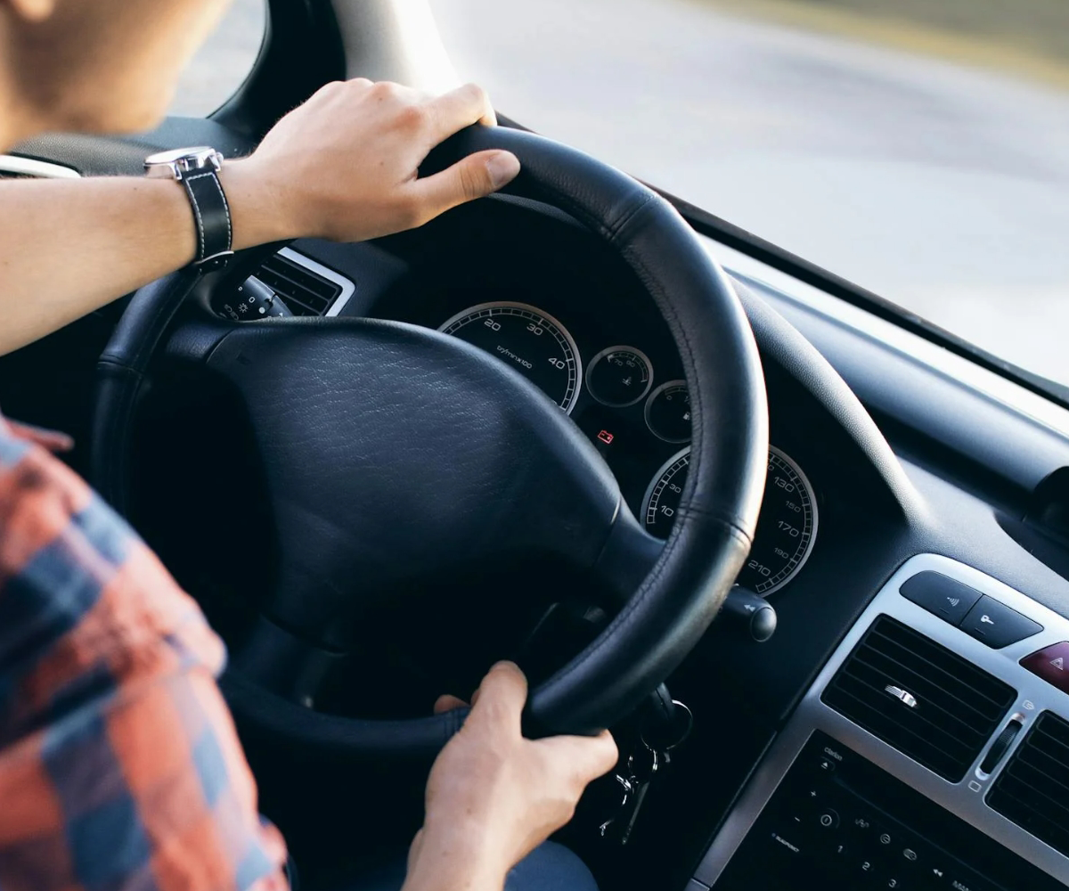 A person behind the wheel of a car.