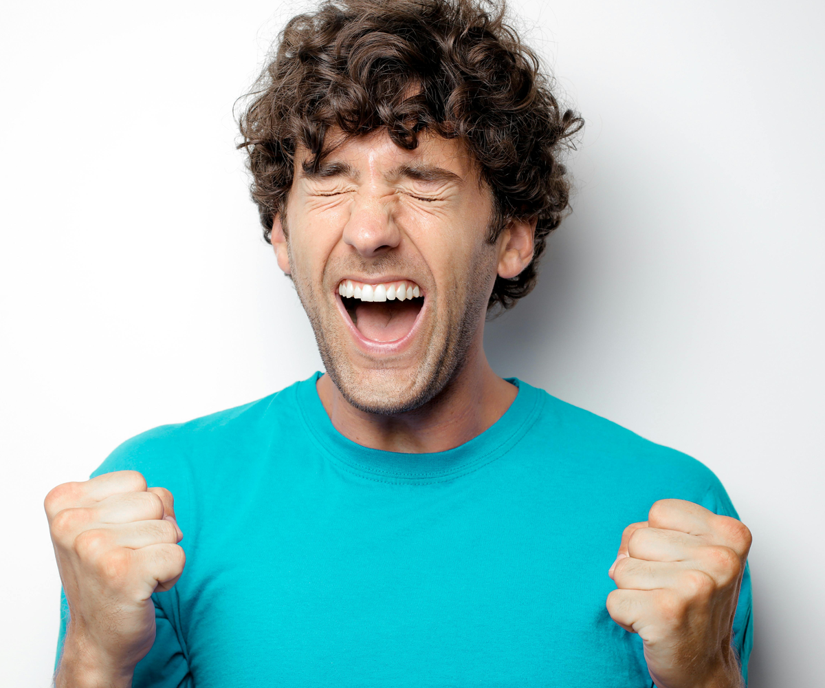 A young man making an excited expression.