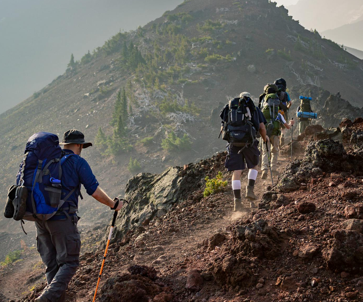 A group of people hiking on a hill.
