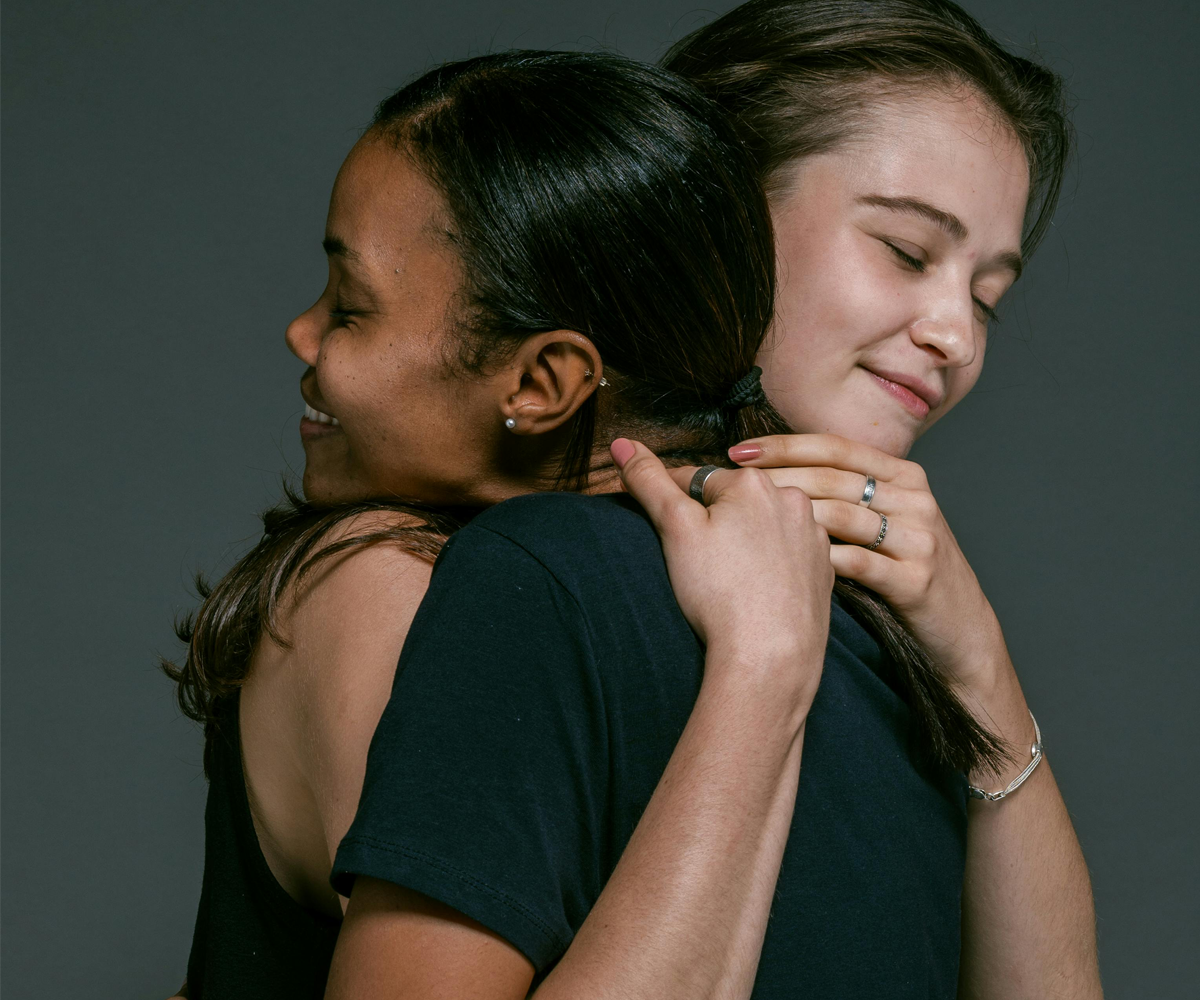 Two women hugging each other.