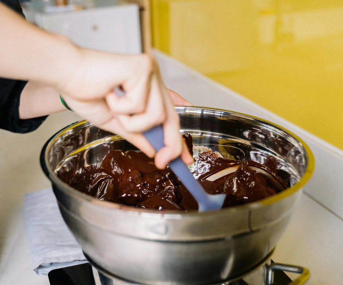 A person mixing a bowl of chocolate.