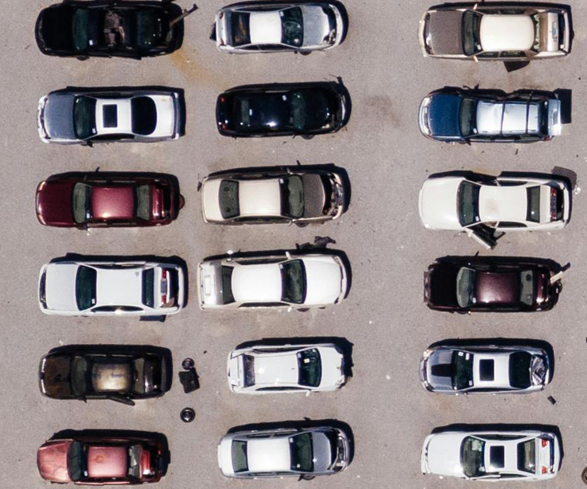 Aerial view of cars parked in a parking lot.