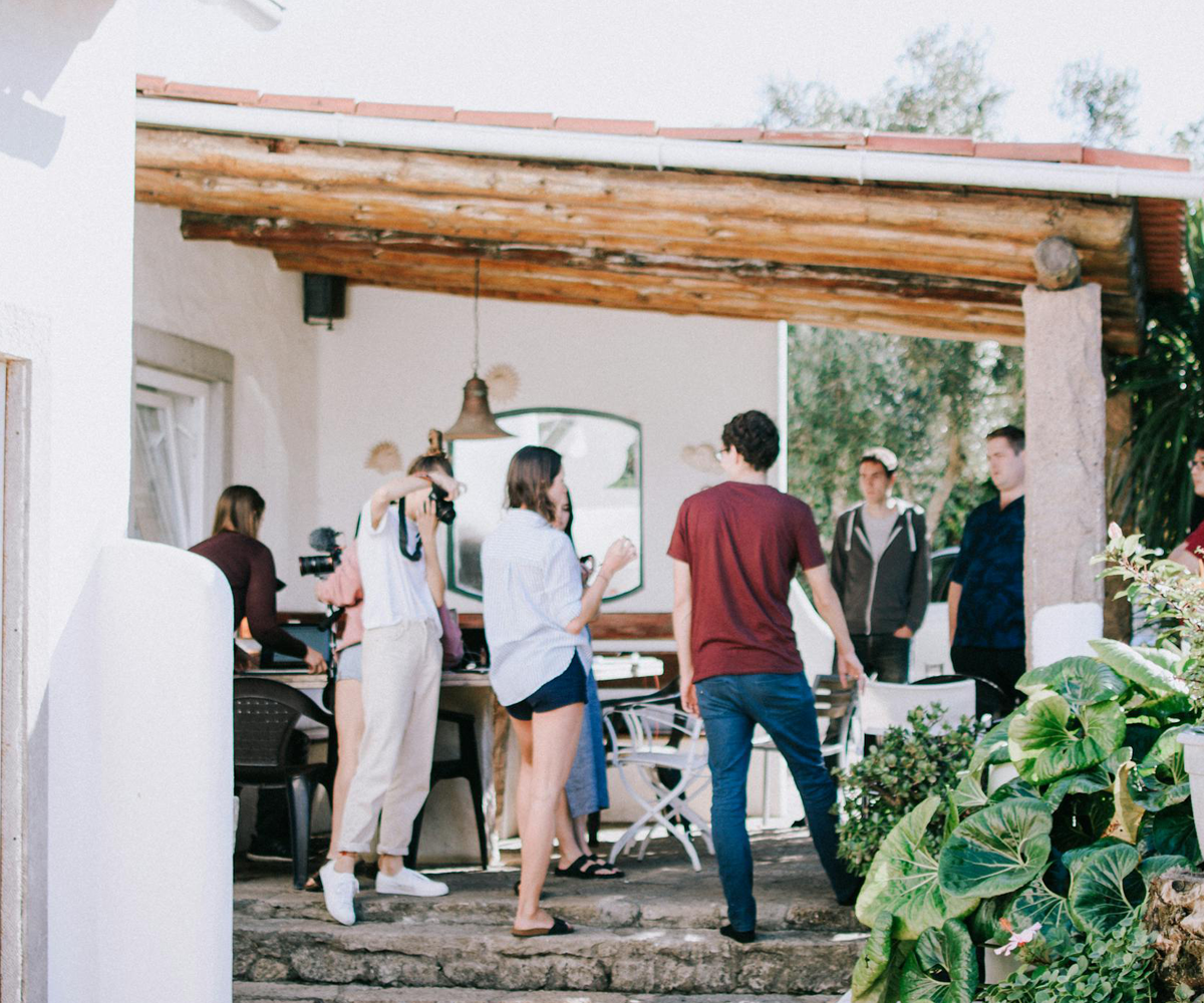 A group of people standing on an outdoor patio.