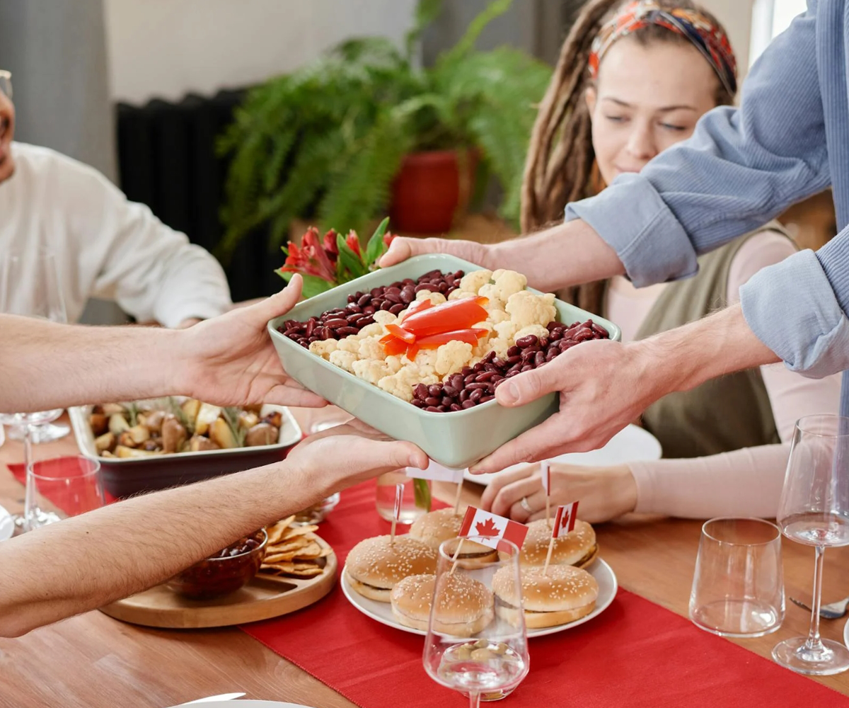 A group of people sharing food around a table.