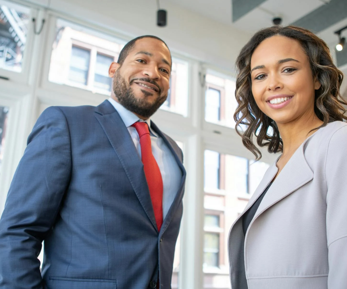 A man and a woman dressed in professional clothes.