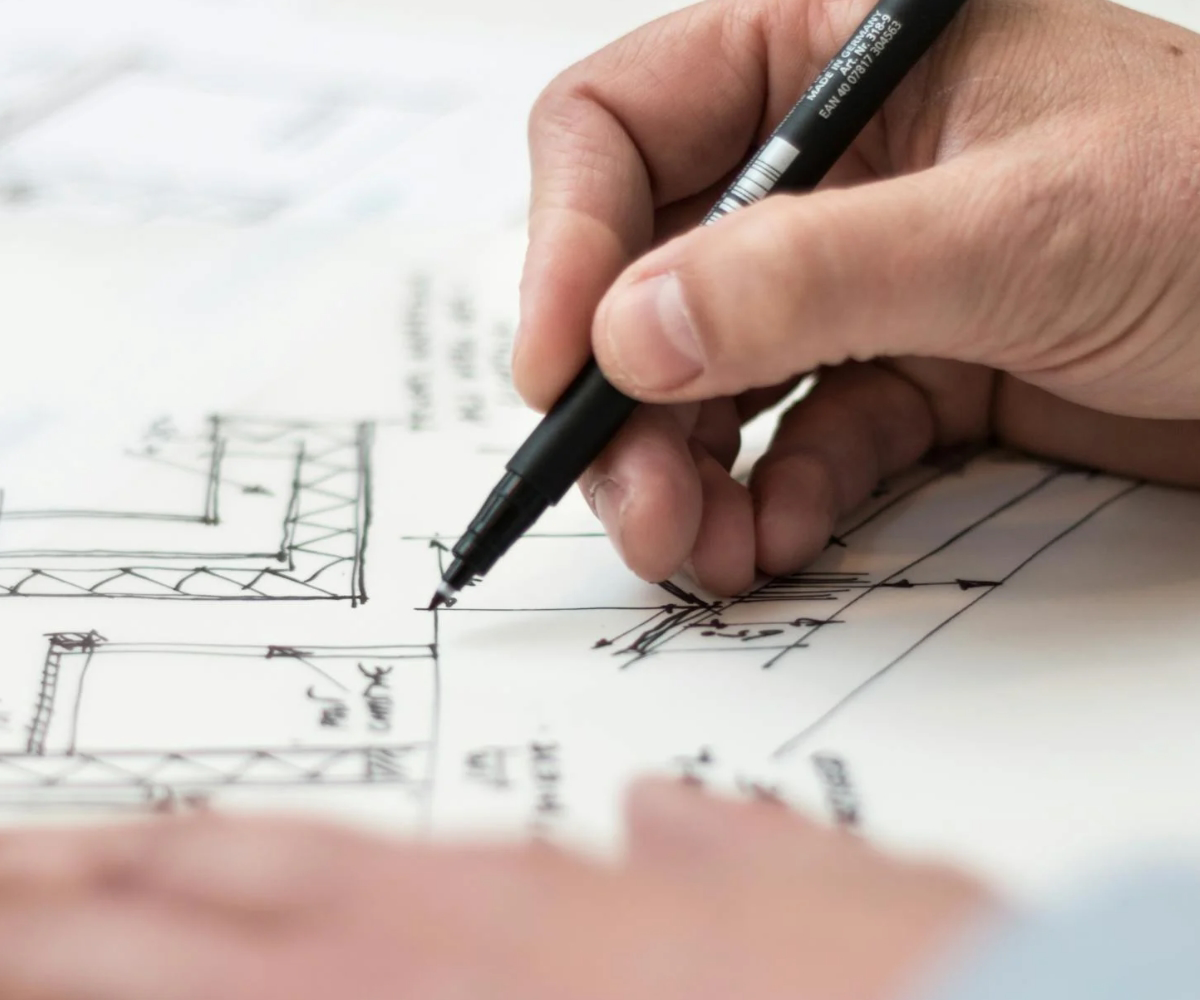 A person writing with a marker on paper.