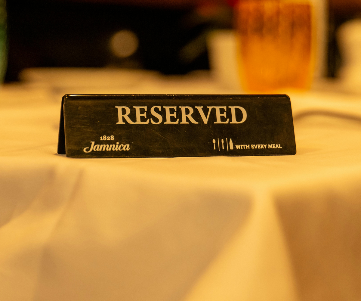 A 'reserved' sign on a restaurant table.