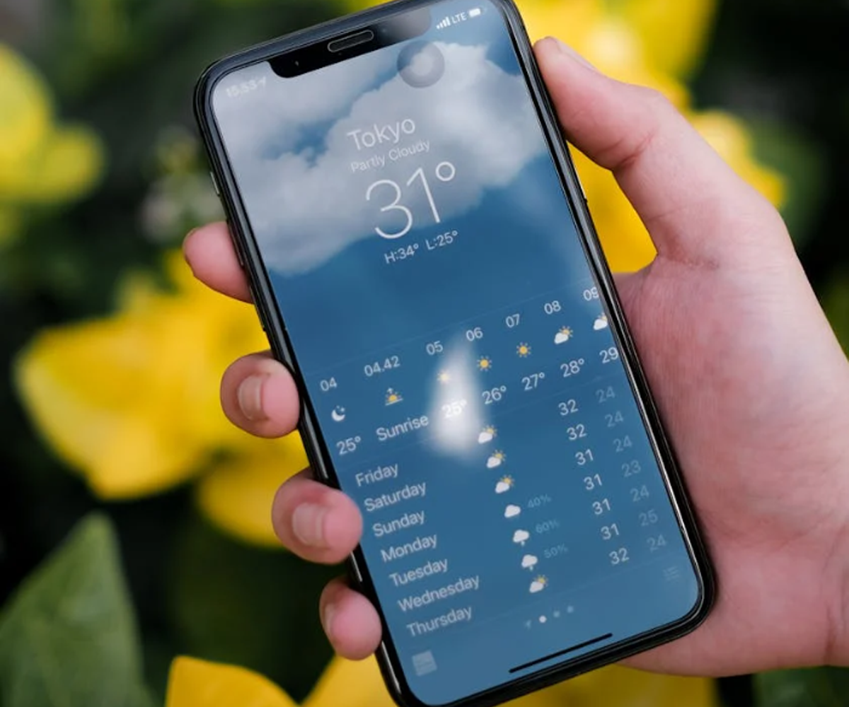 A mobile phone displaying a weather forecast in a weather app.