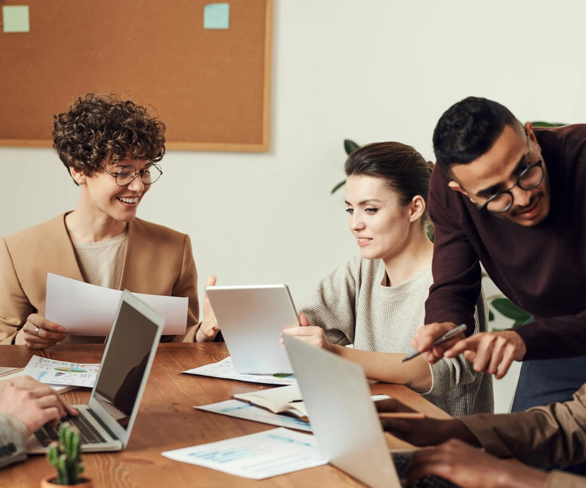 A group of people at work, sitting around a table.