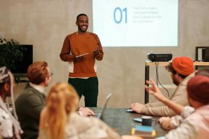 Man presenting in front of a group.