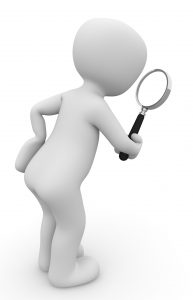 A plain white cartoon figure stands leaning to the right, holding a magnifying glass as if to inspect something.