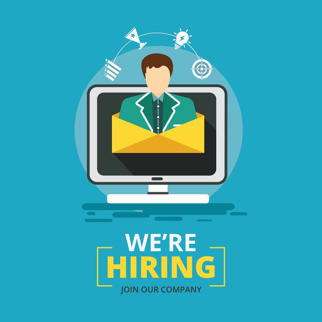 An illustration with a person on a computer screen and the words "We're Hiring" below the screen