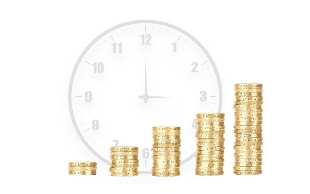 A clock with stacks of coins growing over time.