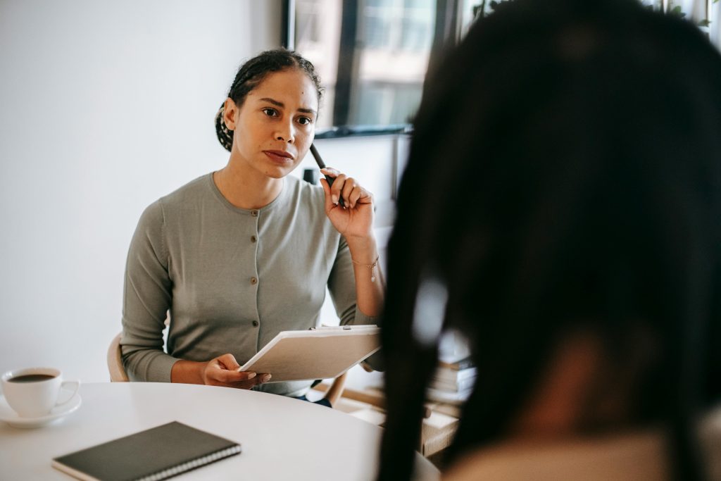 Manager sitting with employee discussing performance