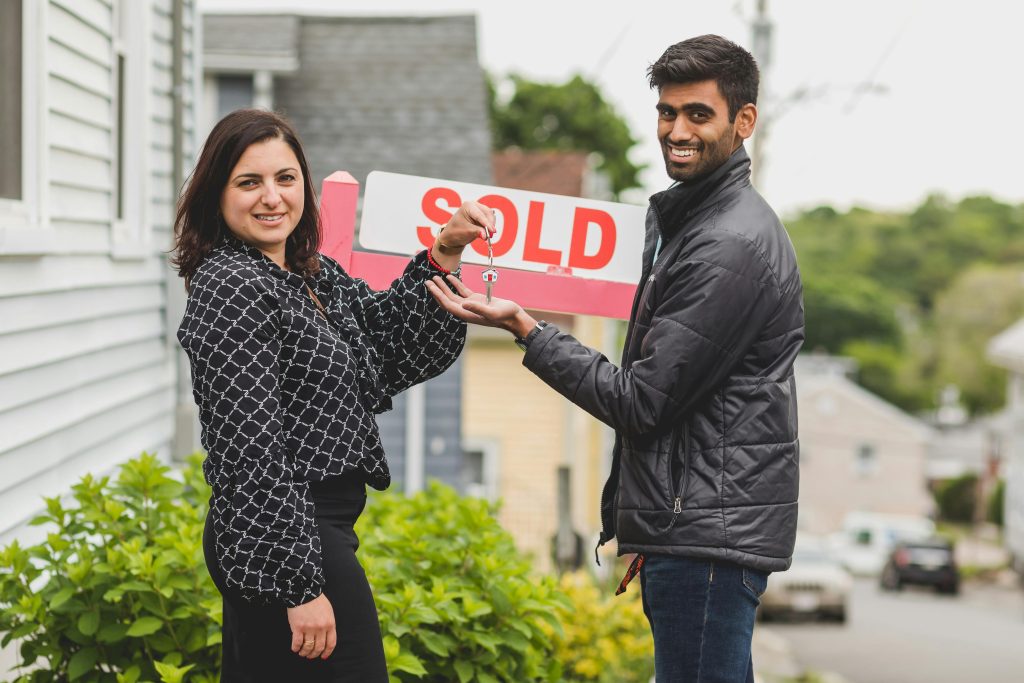 Realtor handing keys to new home buyer