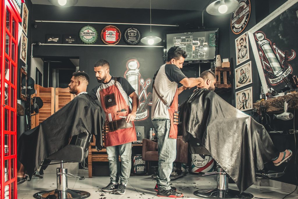 Hair studio with two barbers cutting two customers hair