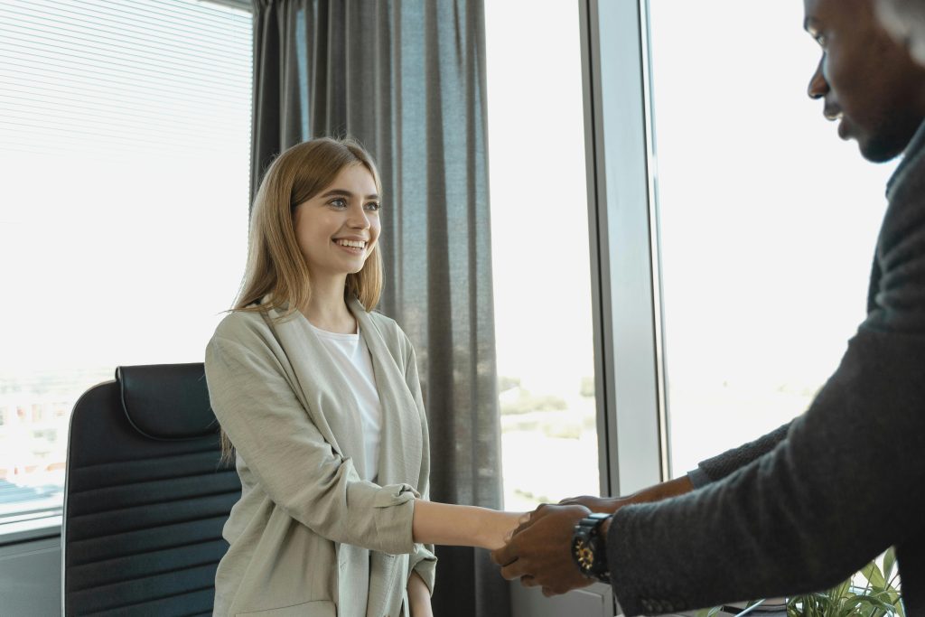 Women just hired shaking hands with a new employer