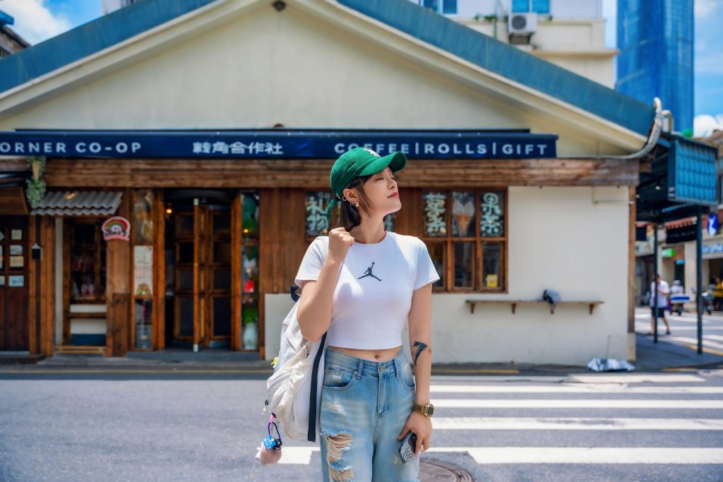 Woman in front of the corner co-op store