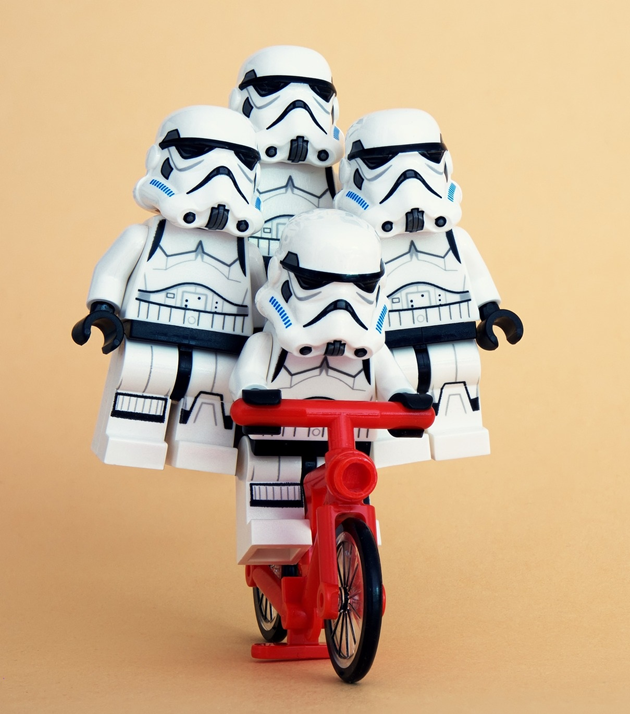 Four Lego storm troopers from Star Wars riding a bike