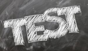 The word "Test" is written on a chalkboard in chalk.