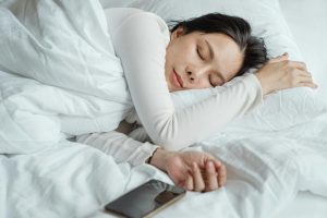A person sleeping in their bed.