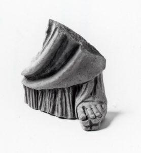 Fragment of female figure, which features a sandal with a high platform sole