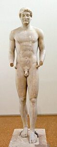 Image of a smooth-skinned male Greek Kouros with stylized pubic hair.