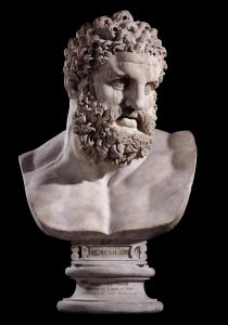 Statue bust of Herakles, bust rests on a small pillar with the caption, "Hercules".