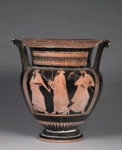 Three symposiasts wearing head scarves, fake earrings, carrying a lyre and parasol