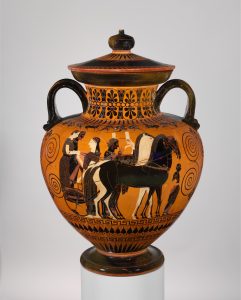A man depicted in black paint and a woman depicted in white stand on a chariot pulled by three horses. Beside them are another man and woman, while a child stands in front of the group.