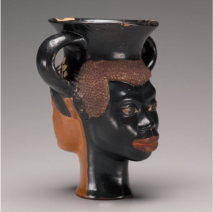 A wide-mouthed cup with the head of African man, represented with curly hair and black clay gloss on one side, and that of a Greek woman with an ivy diadem on the opposite side.