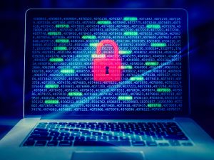 A laptop screen displays a red padlock icon overlaid on a background of green and blue binary code, symbolizing cybersecurity.