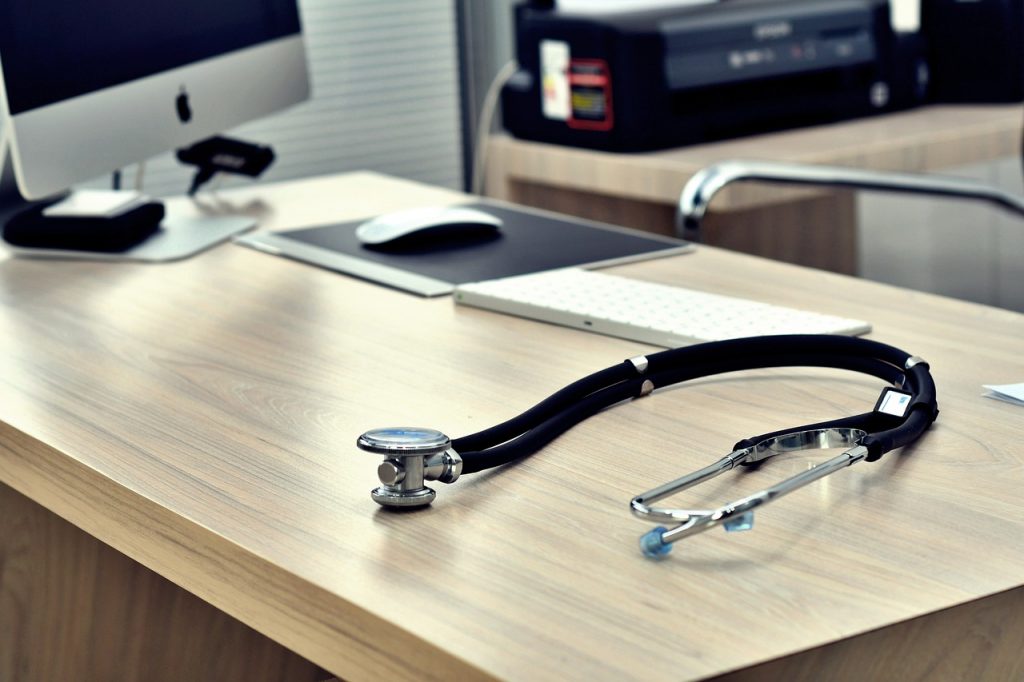 doctor's office with computer and stethoscope on desk