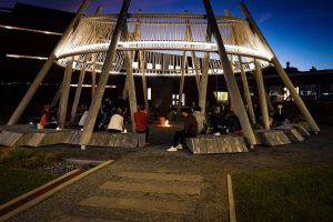 photo by Josh Garbo People sitting around fire in Iskodewan circle, Algonquin College courtyard