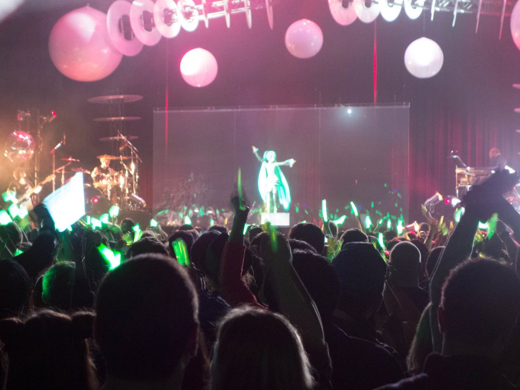 Rear cast projected image of Japanese virtual pop star Hatsune Miku performing "live" in concert
