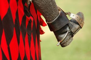 A knight's leather boot in a stirrup.