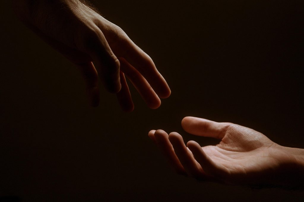 Two hands coming together
