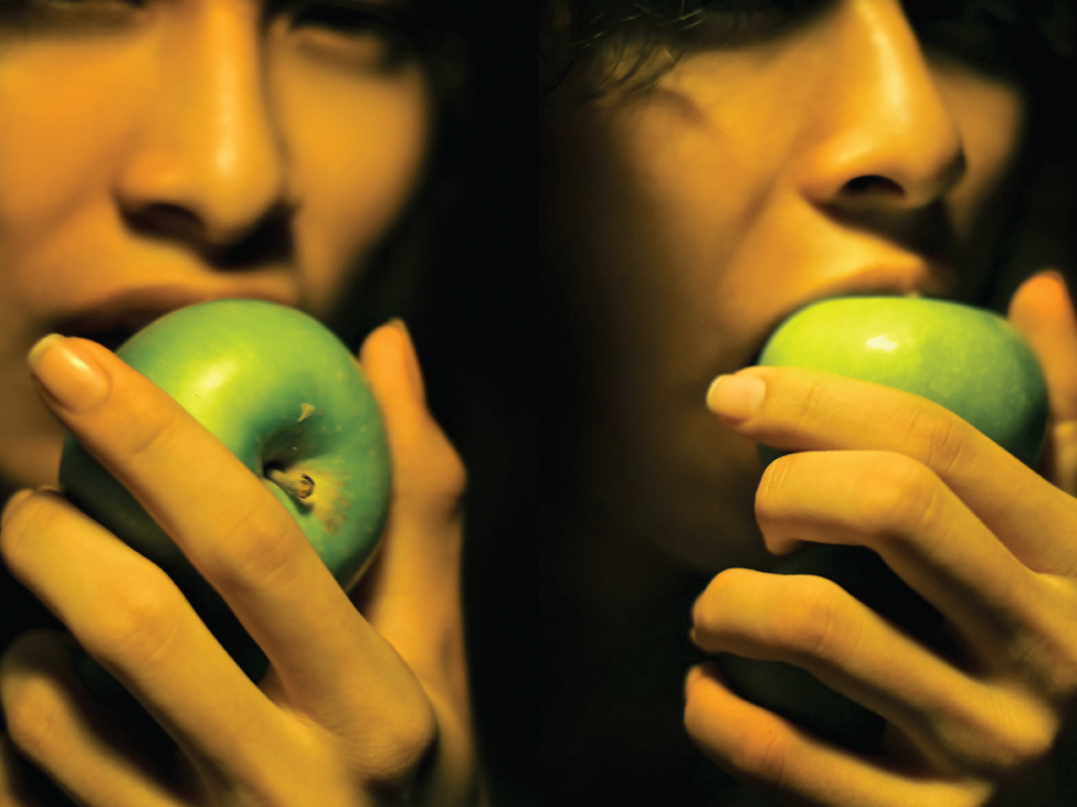 This photograph shows two women eating apples.