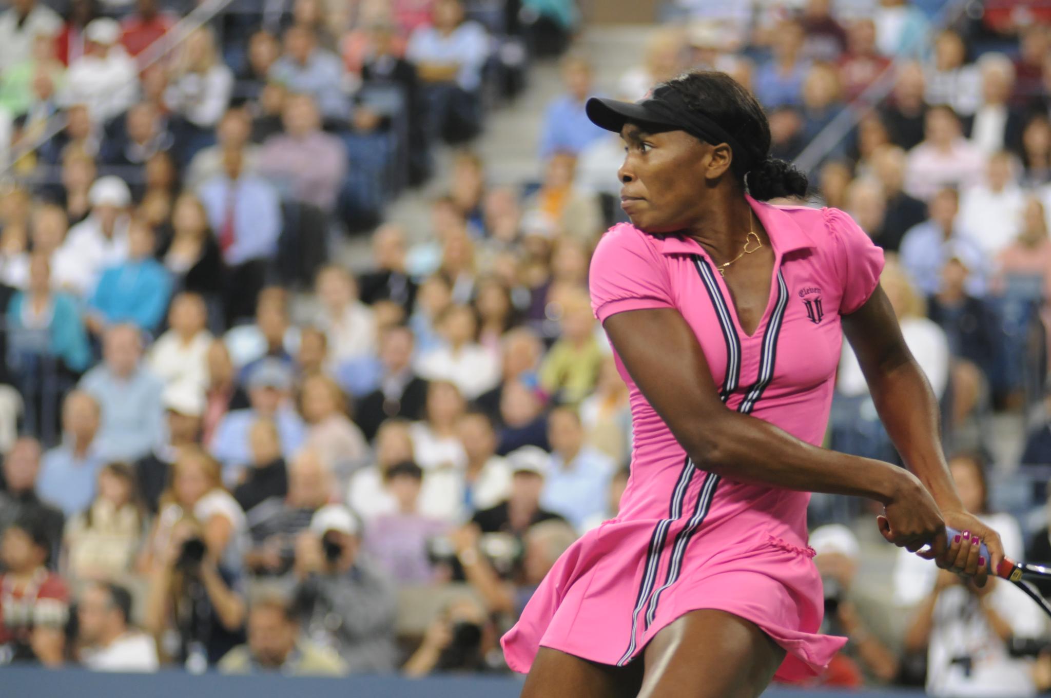 This is a photo of Venus Williams, the famous tennis player, executing a hard tennis swing.