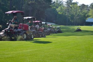 Lawn mowers cutting the grass at a golf club