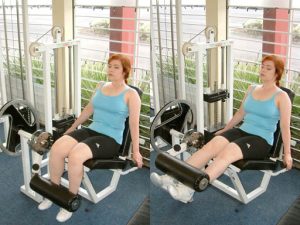 Person using the leg extension machine.