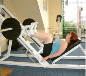 A person using a leg press.