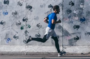 Photo of a man running represents an example of human gait.