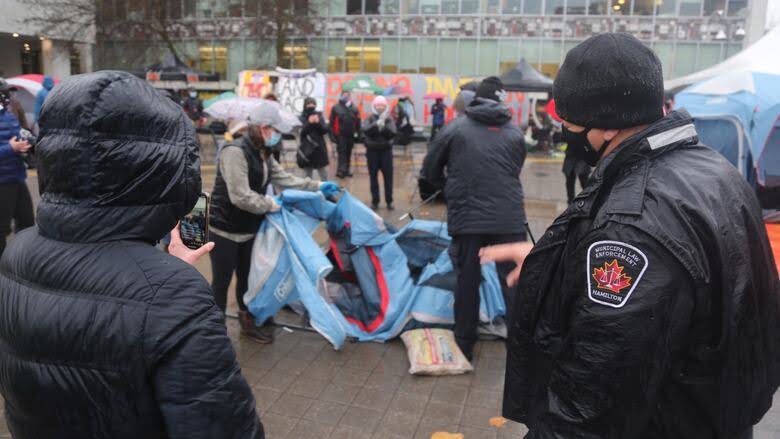 Hamilton By-Law Officers dismantling tents at Freedom Camp