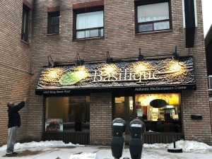 Sabreina's dad standing infant of his store Basilque in Westdale