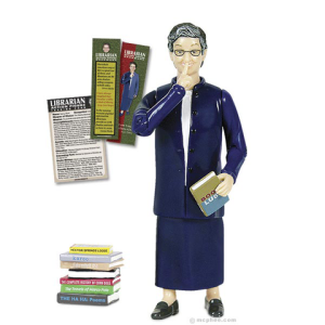 Action figure of librarian Nancy Pearl. She is holding a book in one hand and holding her other hand to her lips to shush.