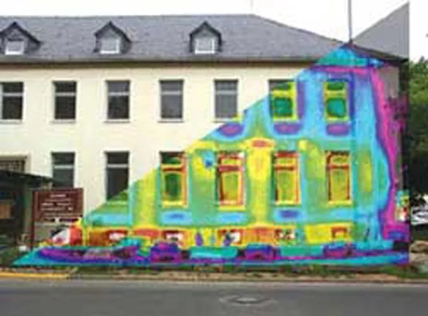 A thermograph of part of a building is shown. The temperature variations are shown in different colors. The region near the windows is more yellowish green, with reddish frames, showing that the windows are major regions of radiative heat transfer.