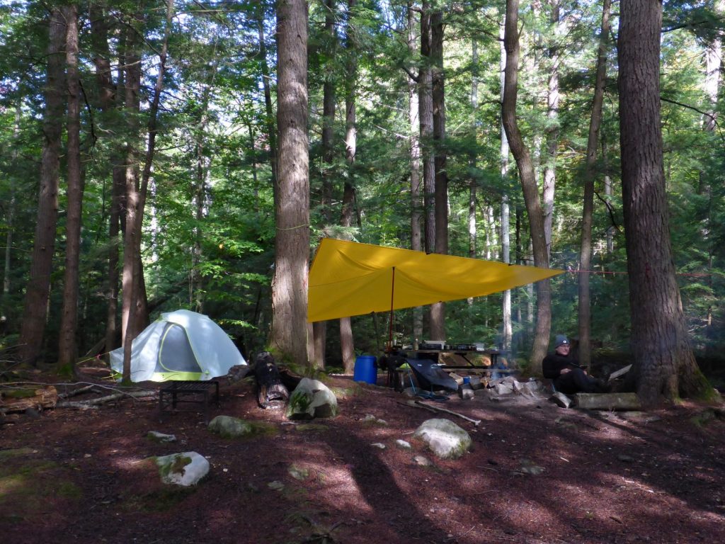 photo of a campsite with a tarp and a tent