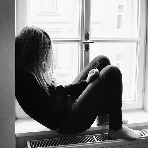 B&W image of female in window alcove